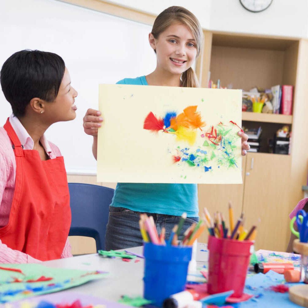 stock-photo-elementary-school-pupil-talking-about-picture-in-art-class-12043753