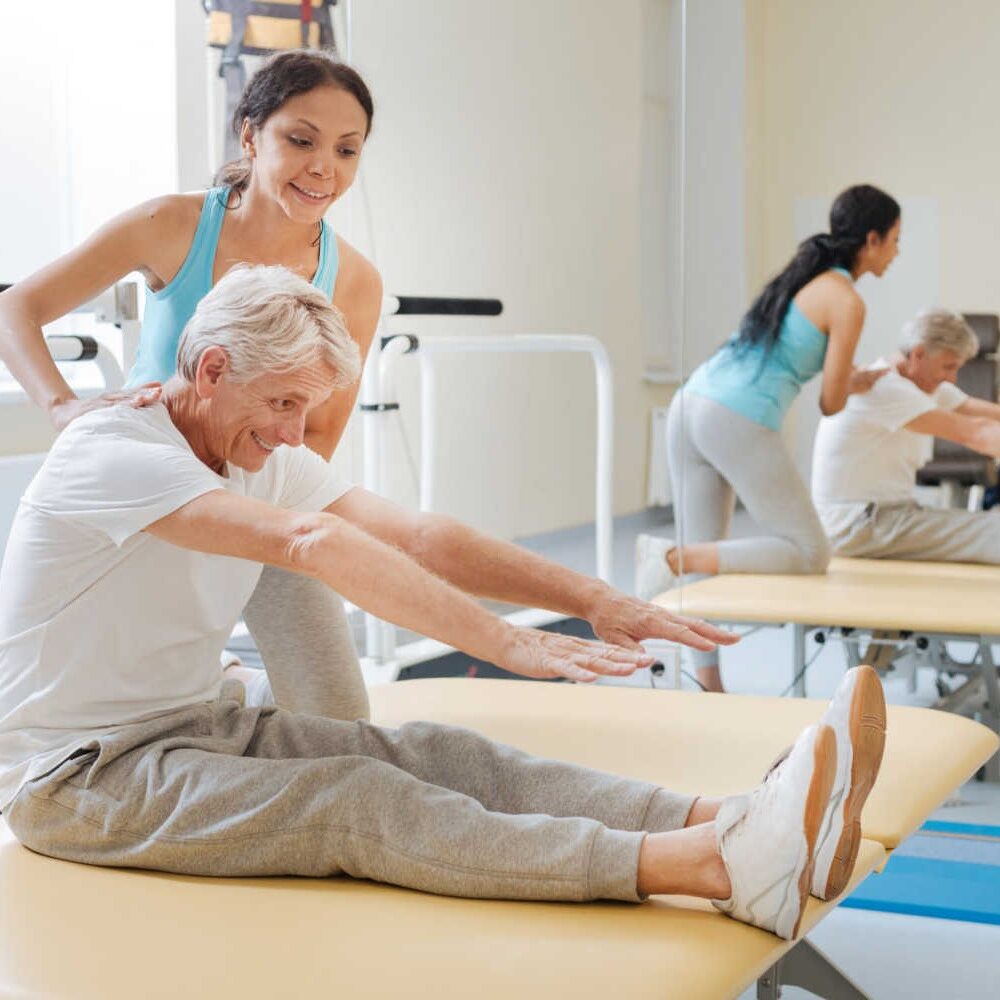 stock-photo-positive-delighted-retirement-doing-stretching-exercises-691299664