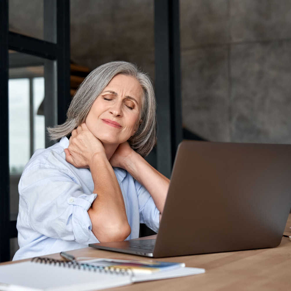 stock-photo-tired-stressed-old-mature-business-woman-suffering-from-fibromyalgia-neckpain-working-in-office-1827070301